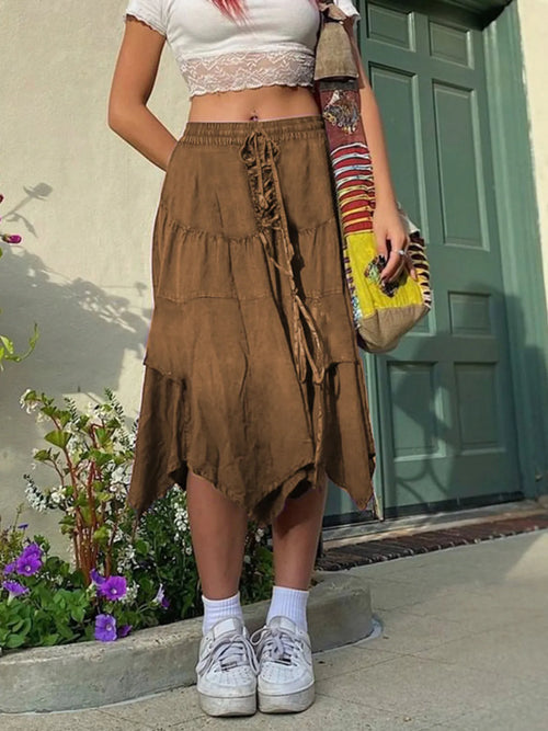 Brown asymmetrical hem midi skirt with drawstring waist and gathered, tiered panels.