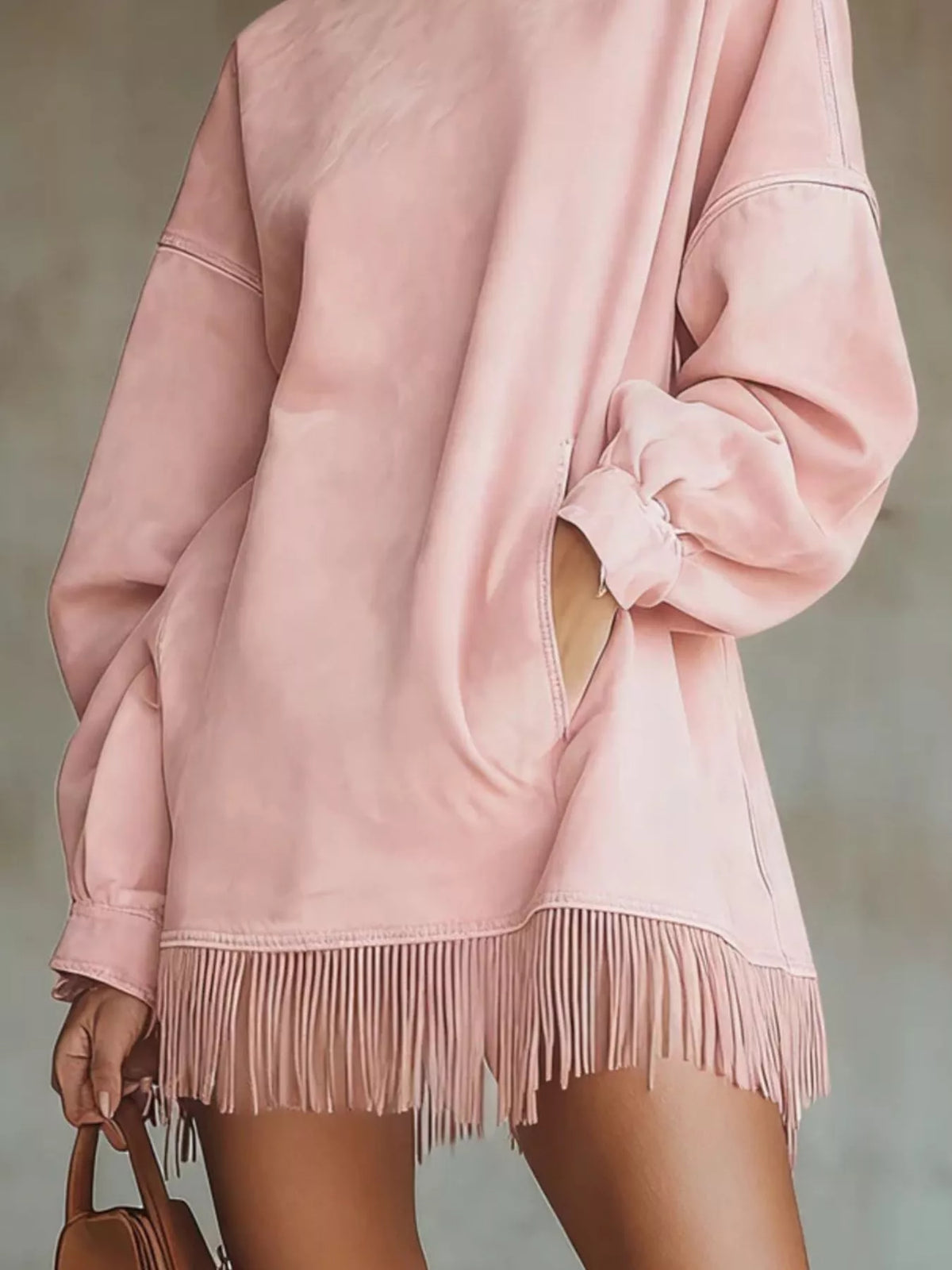 Pink mock neck mini dress with long sleeves, draped cuff and fringe hem