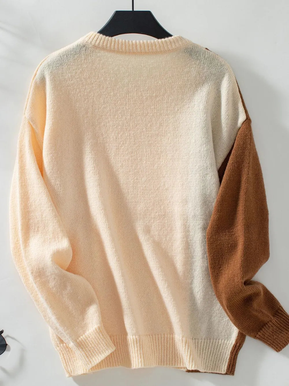 Two-tone cable knit sweater back, cream knit with caramel sleeve panels