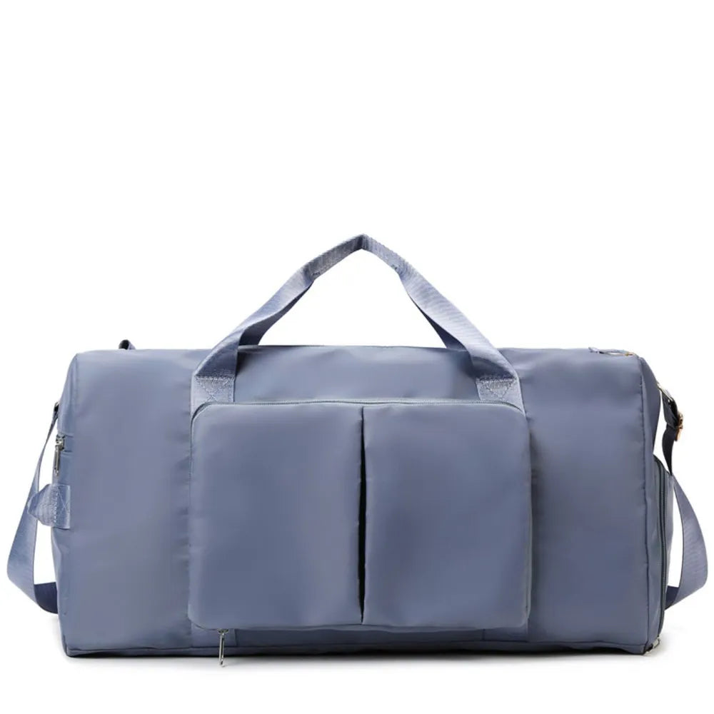 Large travel duffel bag with front zip pocket, dusty blue body and top carry handles