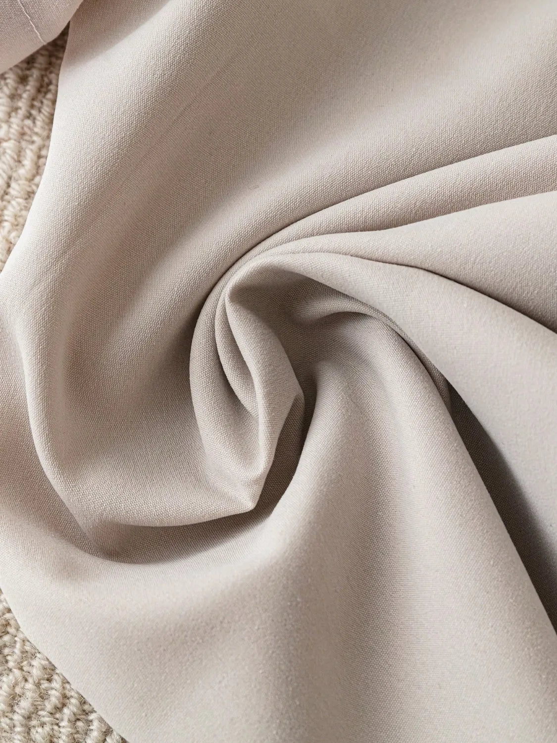 Light khaki blazer fabric close-up with smooth textured weave