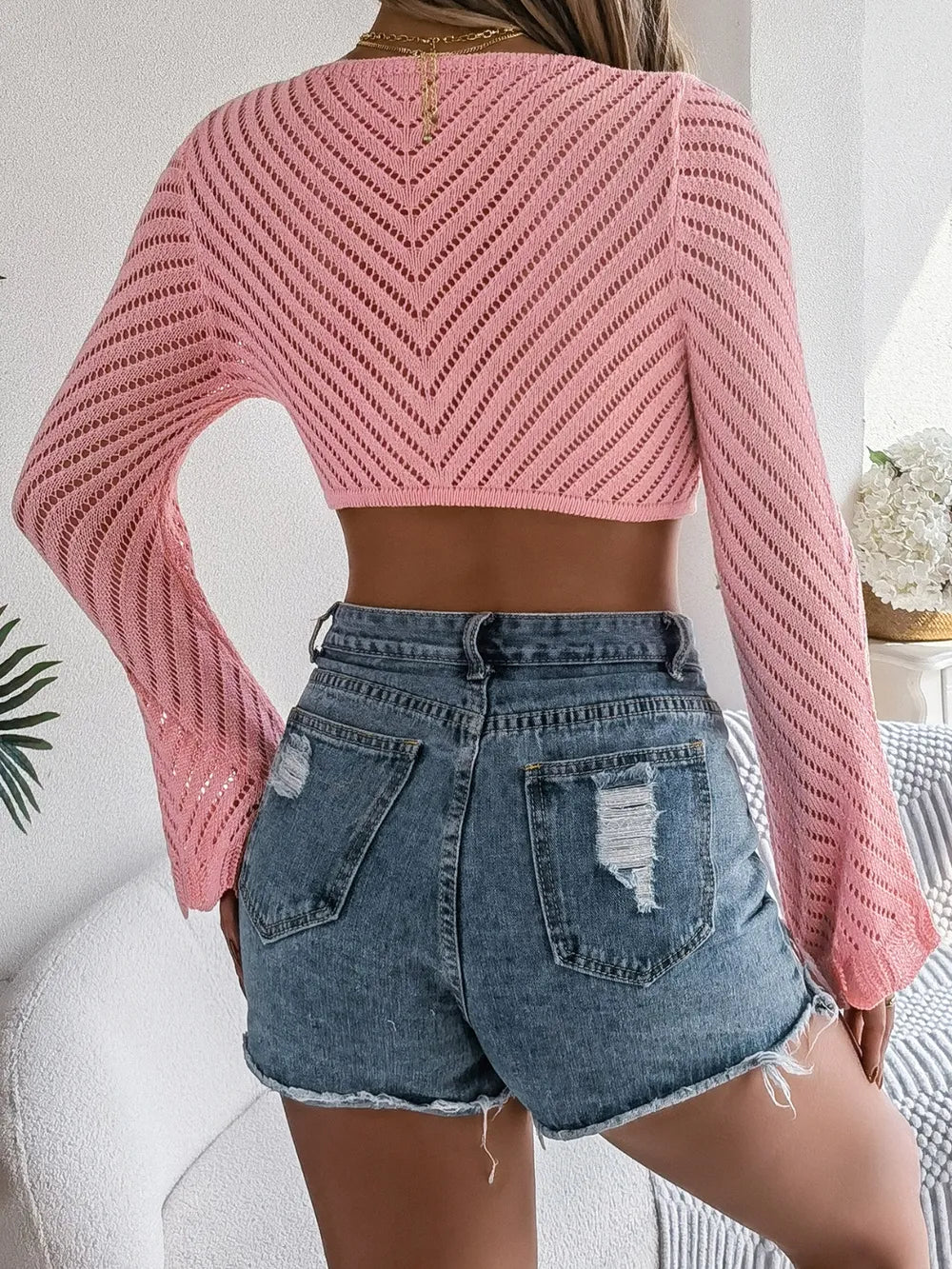 Openwork knit cover-up, dust pink cropped back with long sleeves and openwork pattern