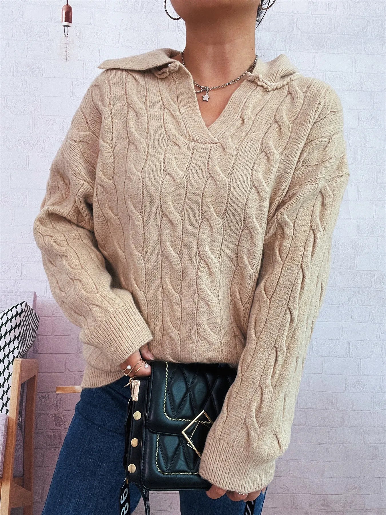 Beige cable-knit Johnny collar sweater with raised cable texture and ribbed waistband
