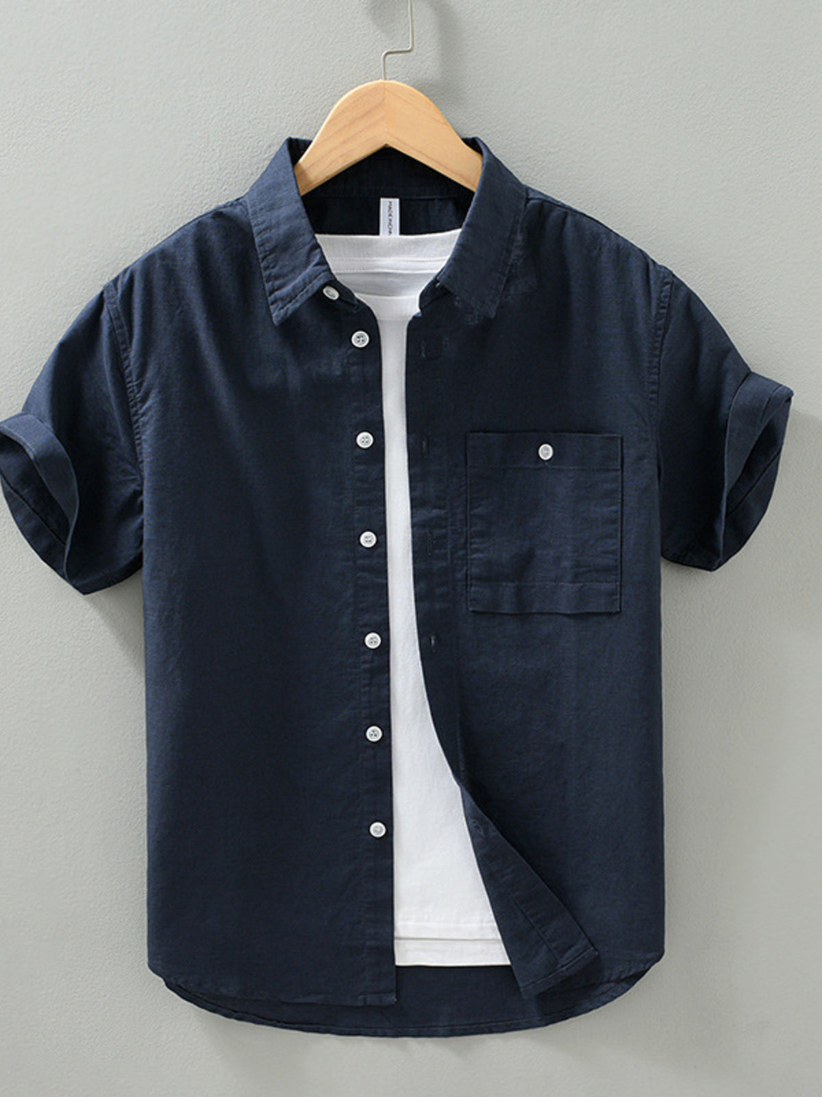 Dark navy men’s short-sleeve button shirt with chest pocket and button front