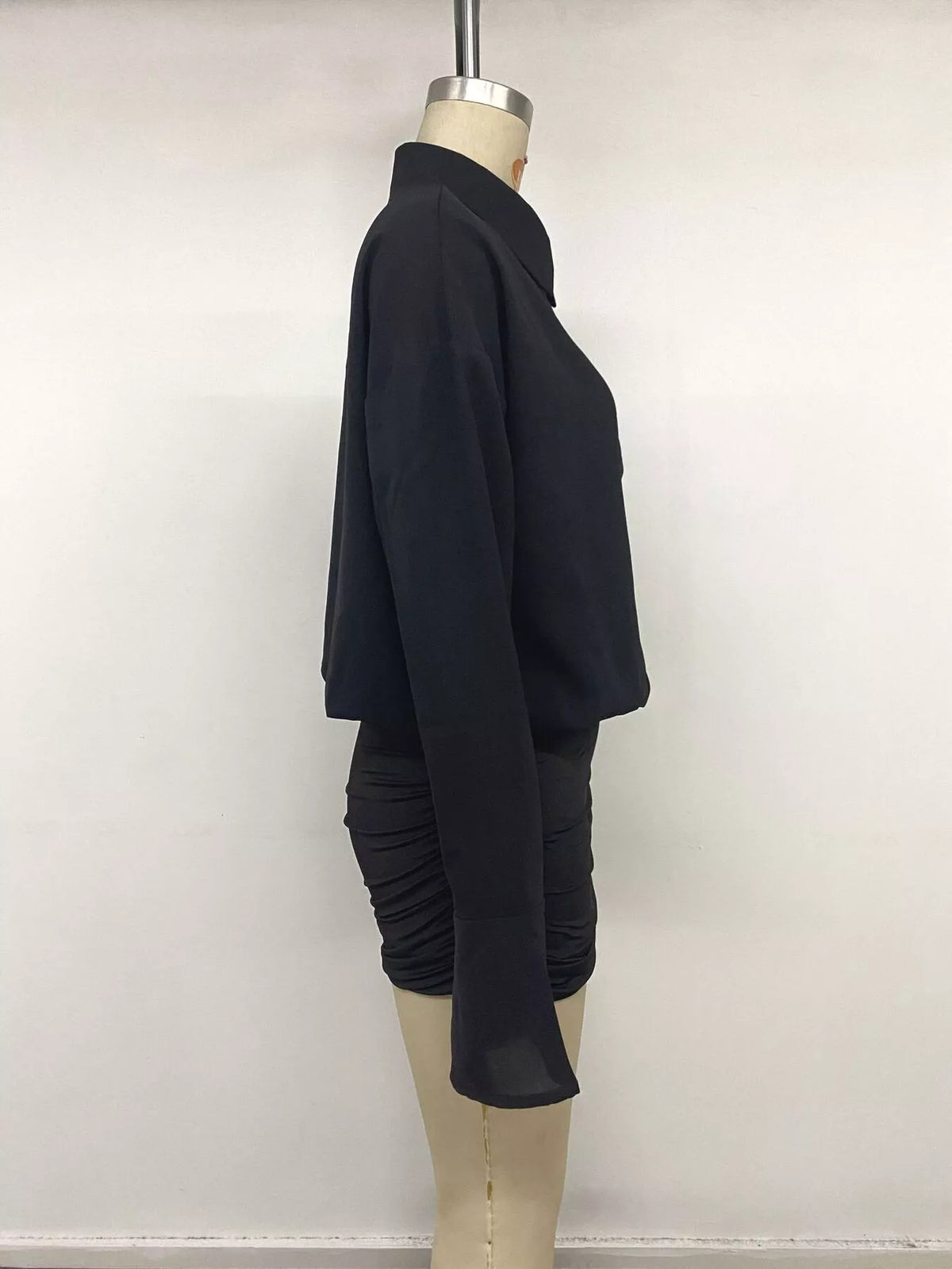 Side view of black button shirt dress with ruched bodycon skirt