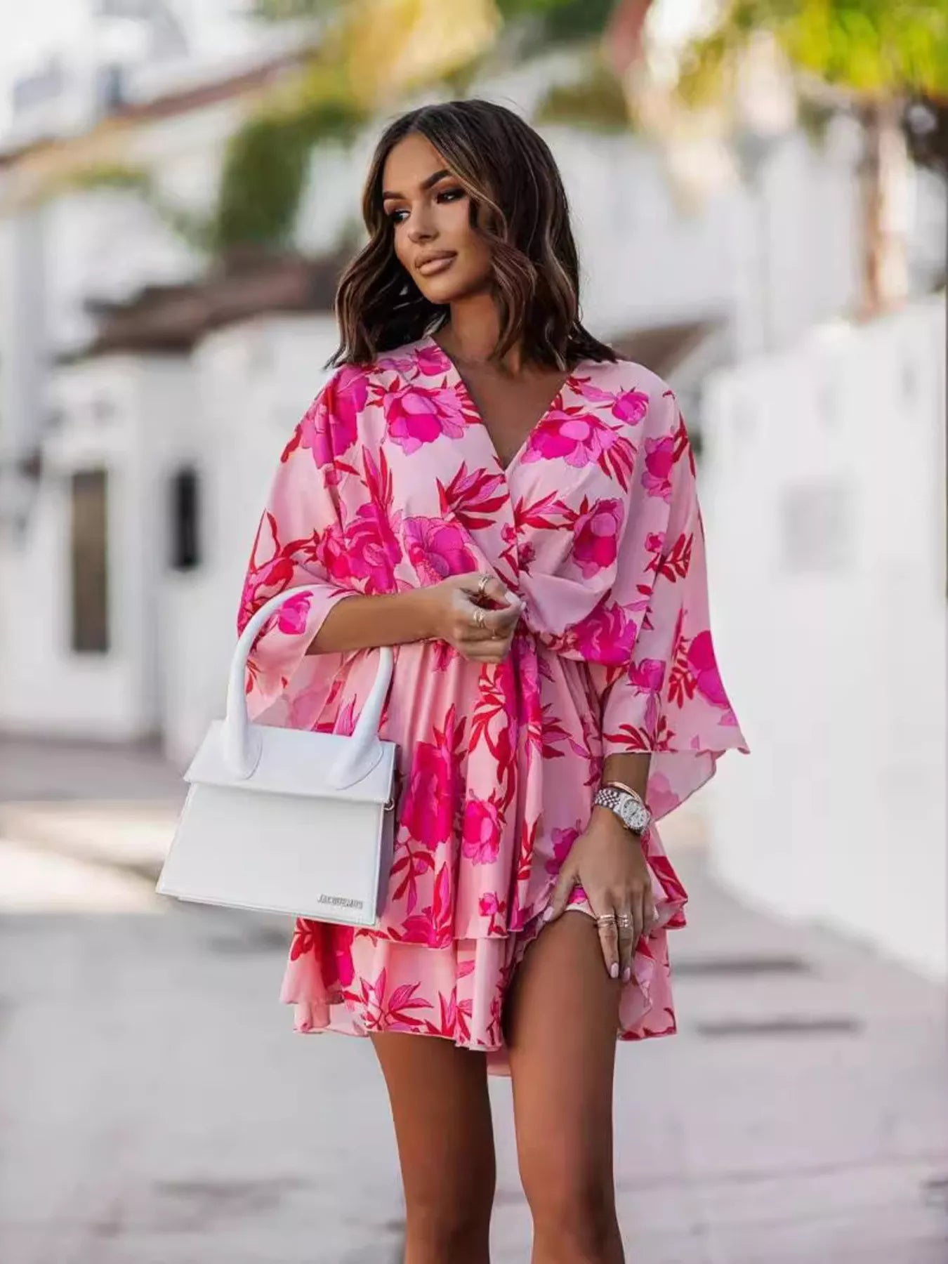 Printed surplice mini dress in pink with large floral print, tiered ruffle sleeves