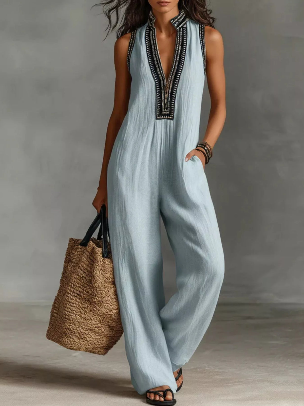 Sky blue sleeveless wide-leg jumpsuit with V-neck and dark embroidered trim