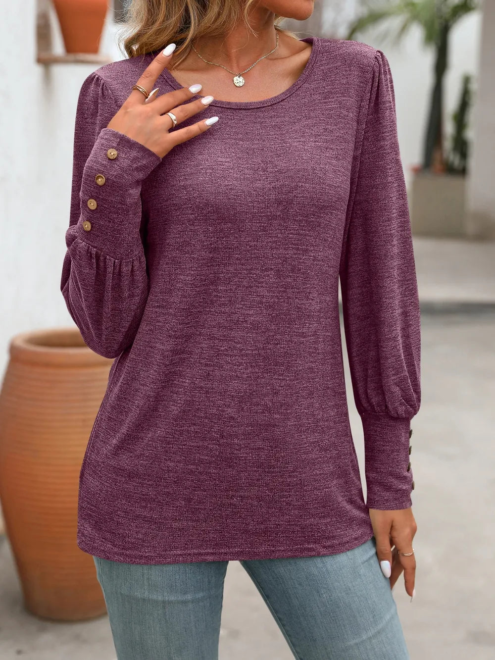Purple long sleeve round-neck t-shirt with buttoned sleeve cuffs
