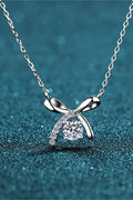 Moissanite sterling silver necklace with bow pendant and round clear gemstone