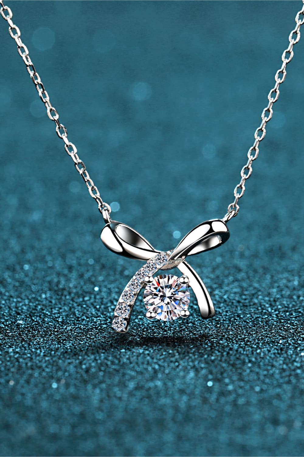 Moissanite sterling silver necklace with bow pendant and round clear gemstone