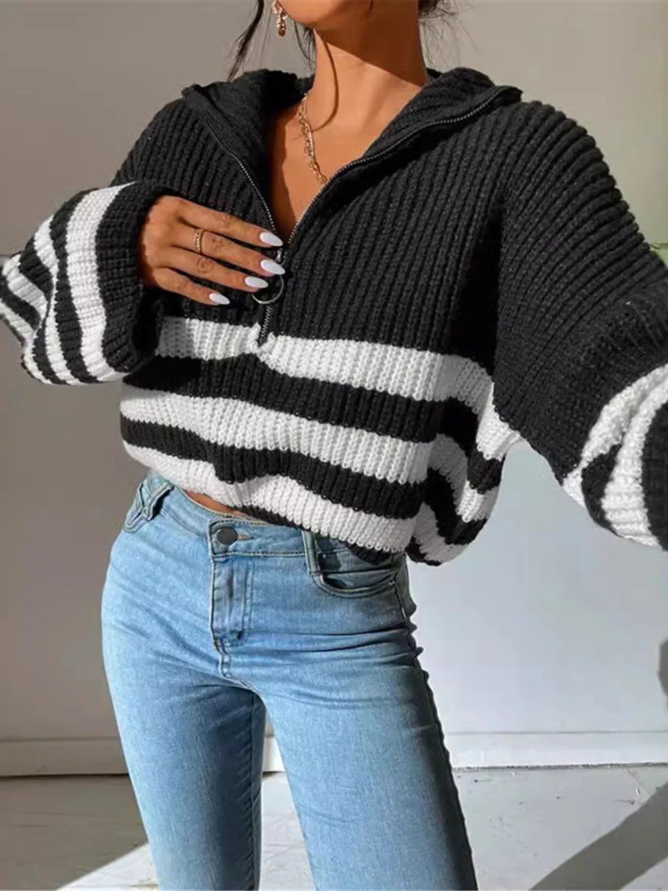 Black cropped half-zip knit sweater with white stripes and ribbed cuffs