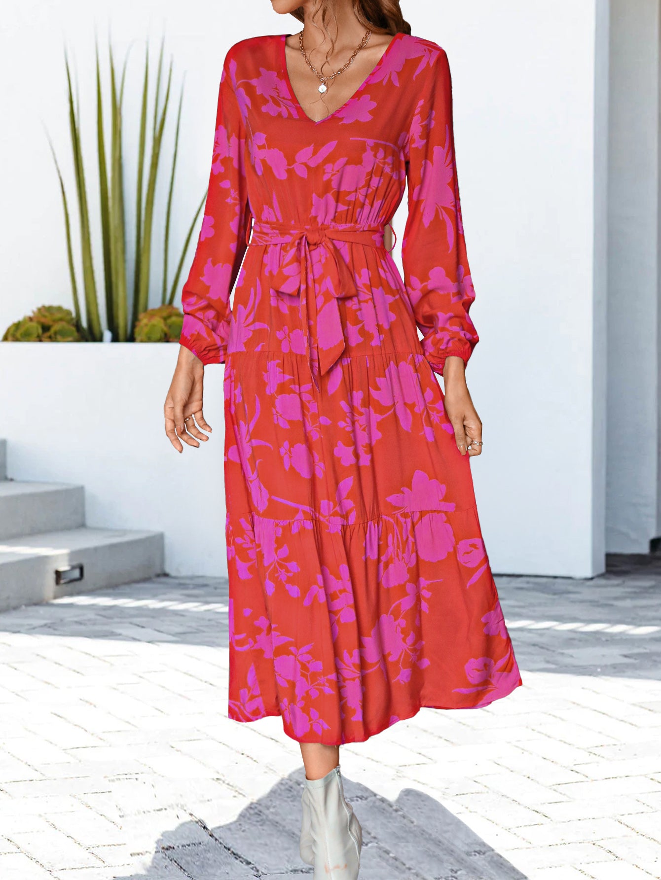 Hot pink floral V-neck long sleeve dress with tie waist and flowing tiered skirt, midi length