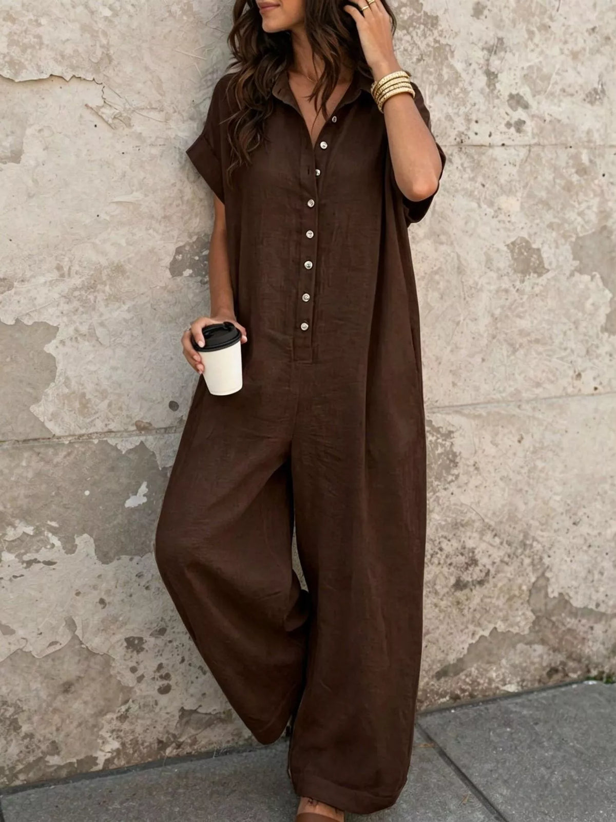 Dark brown button-front short-sleeve jumpsuit with wide legs and chest pockets