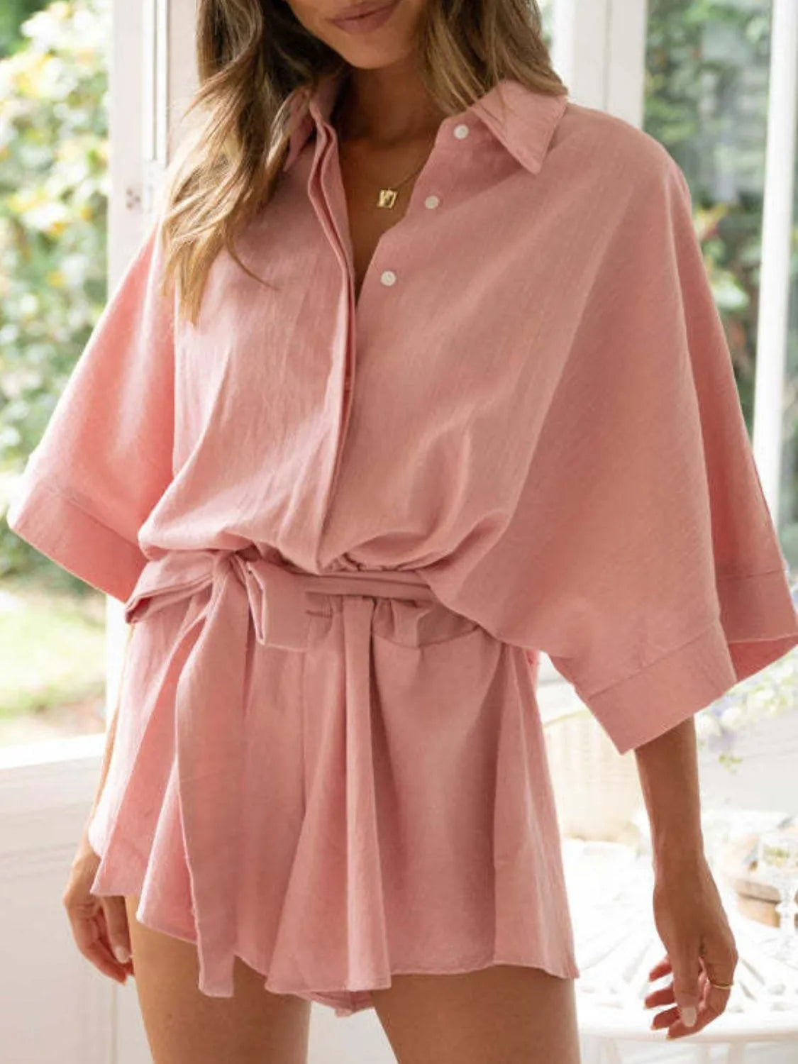 Dusty pink collared half-sleeve romper with button placket and tied waist