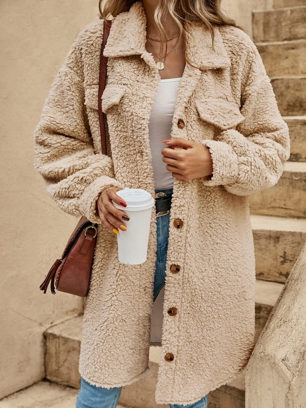 Light tan collared button-down coat with sherpa texture, flap pockets, and button placket