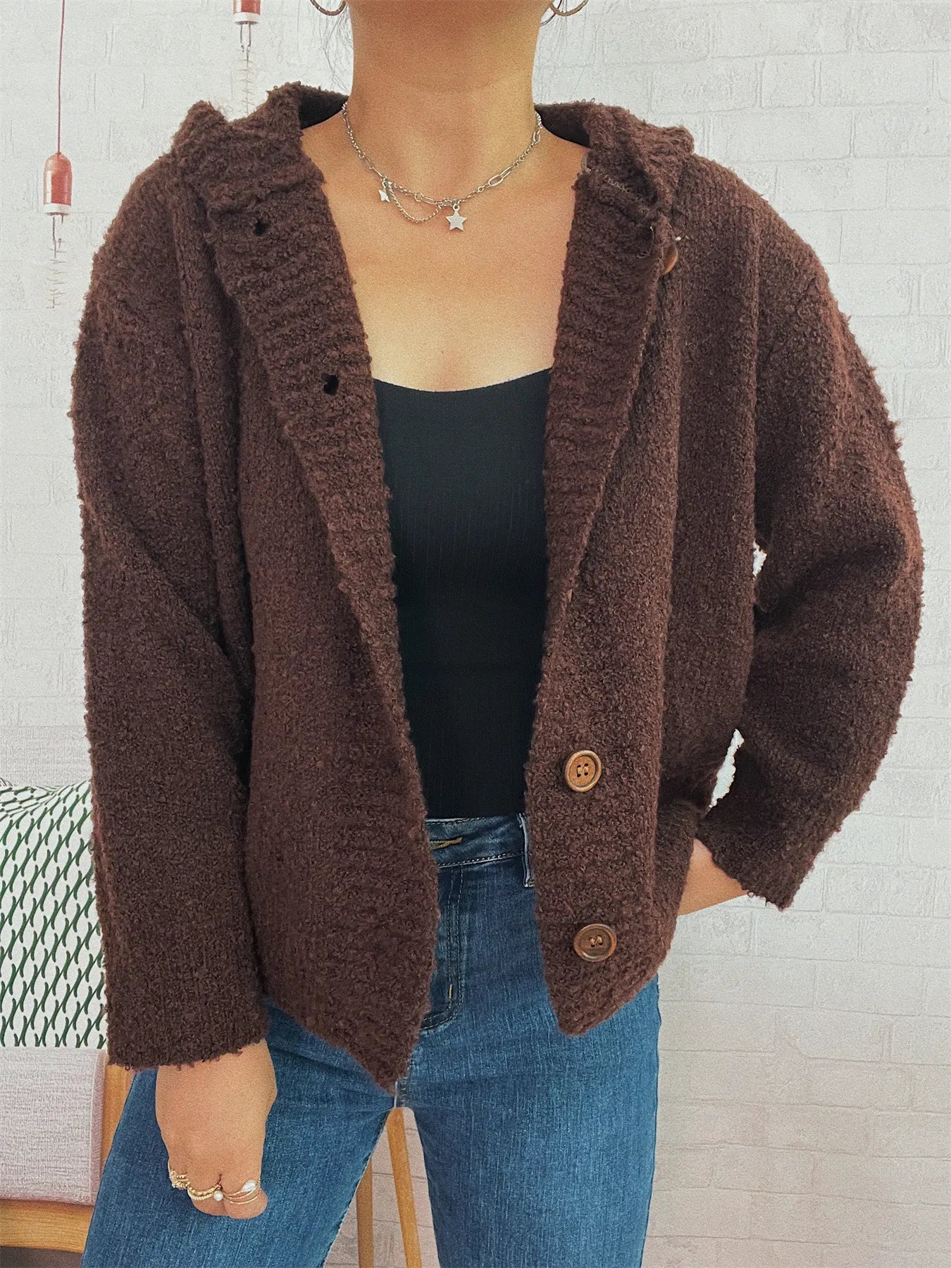 Brown hooded cardigan with wide hood, long sleeves, textured knit, and buttons