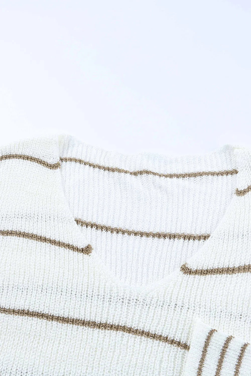 Close-up of white sweater knit with horizontal tan stripe pattern