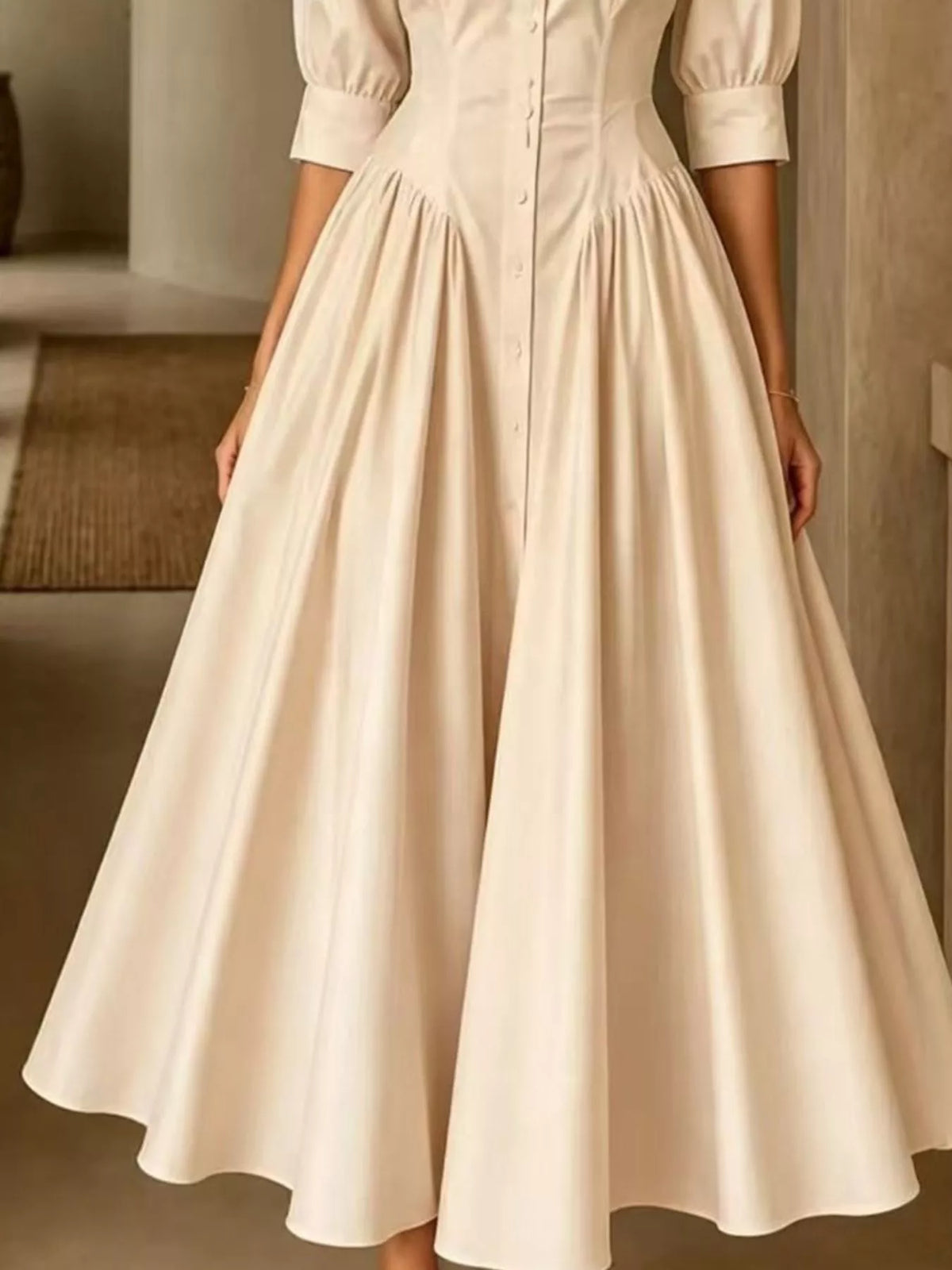 Beige button-down shirt dress side view with cinched waist and flowing skirt