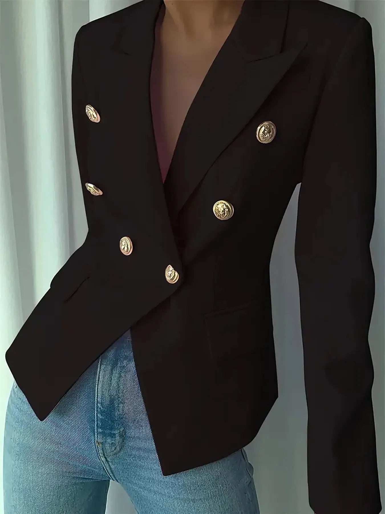 Black fitted blazer with gold-tone coin buttons on lapels and sleeves; structured shoulders