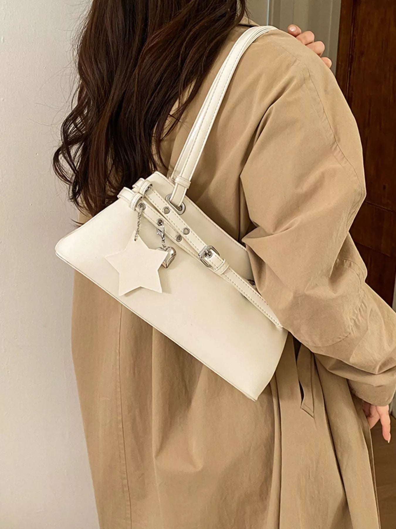 White vegan leather shoulder bag with star buckle decor and top handles
