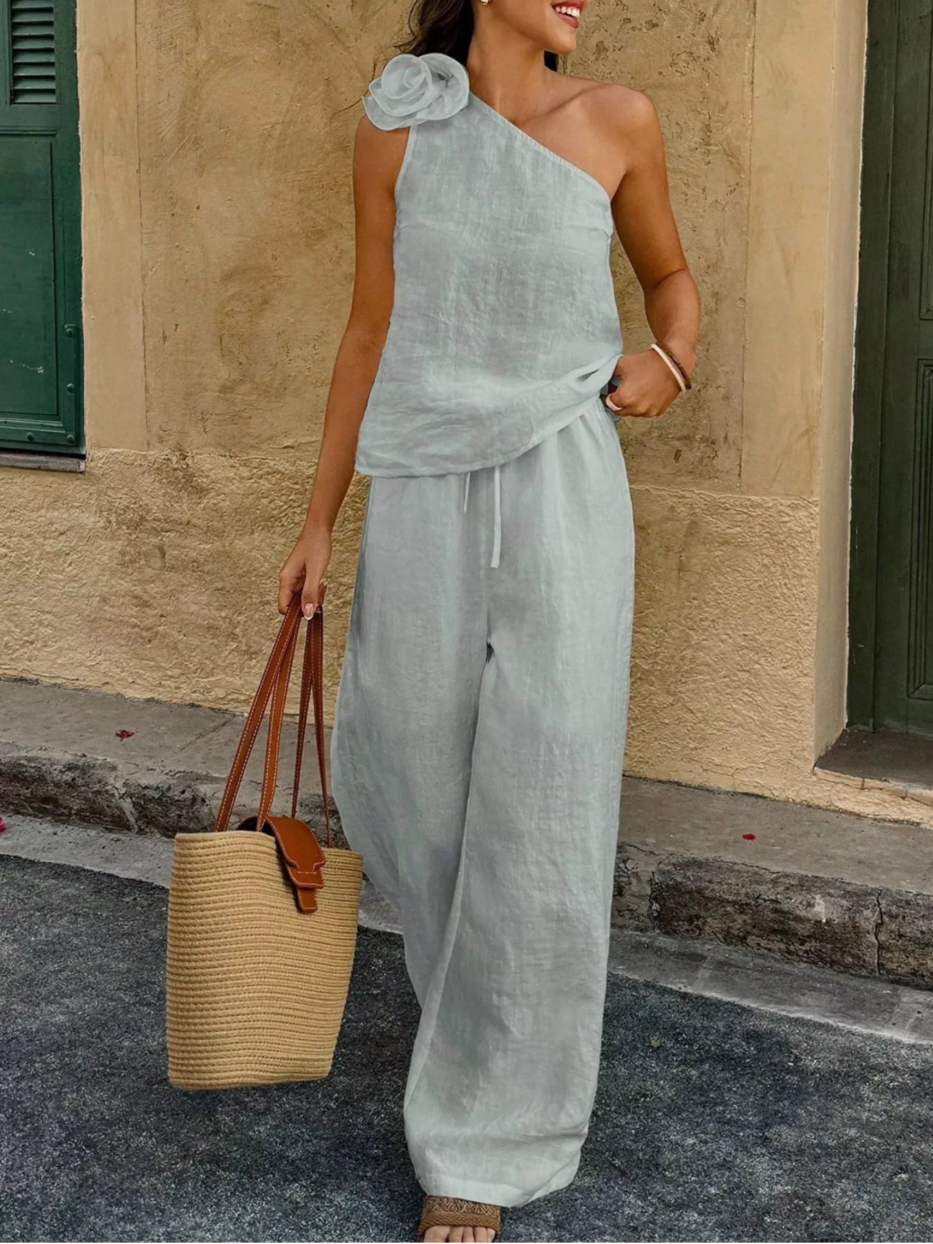 Light blue one-shoulder floral embellished top and wide-leg pants set with waist tie