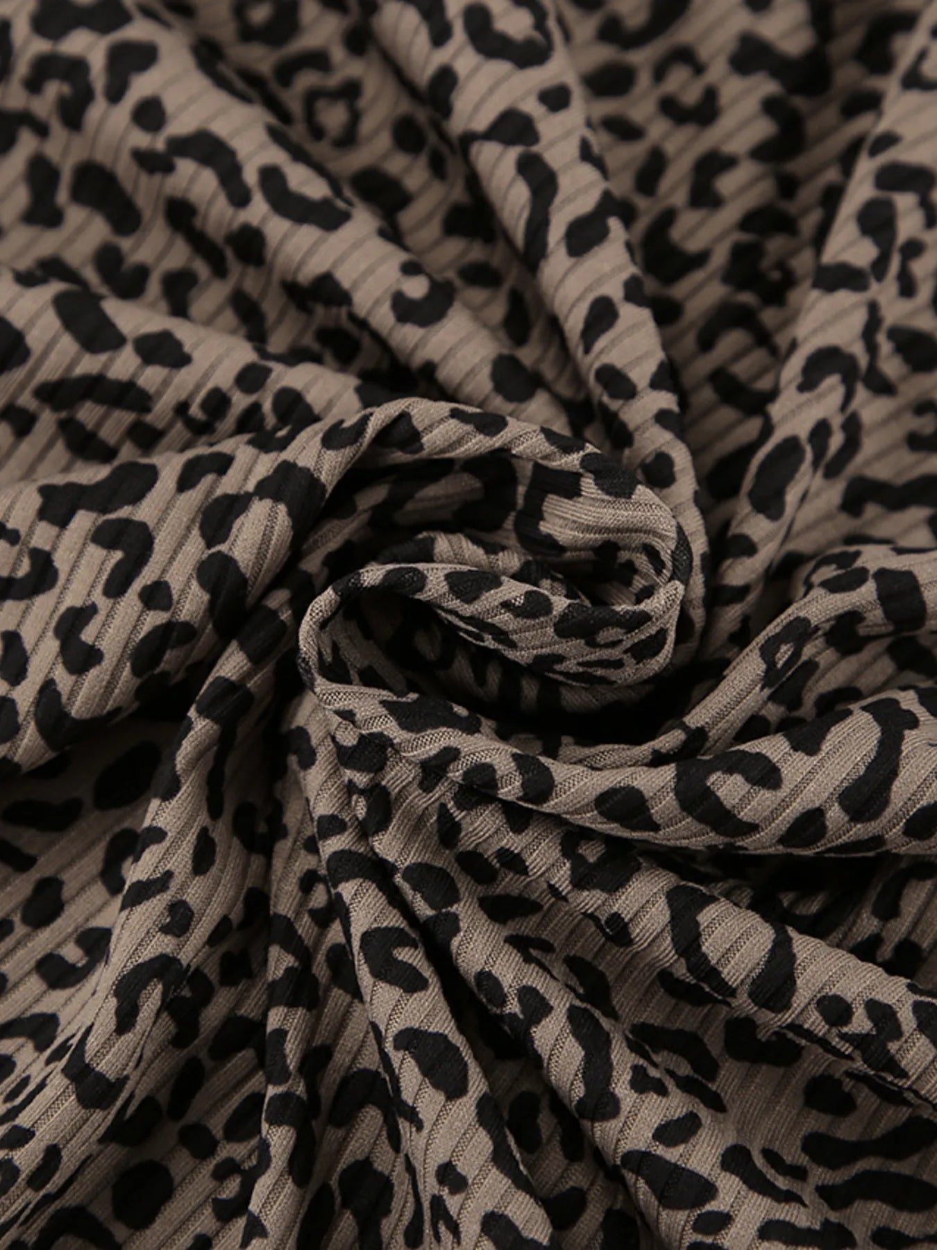 Leopard print fabric with gathered seams and soft knit texture