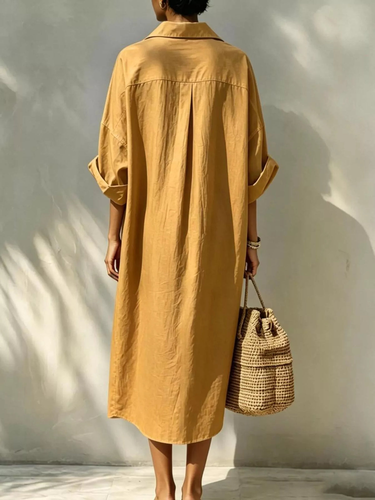 Mustard button-front shirt dress, back view with wide draped silhouette