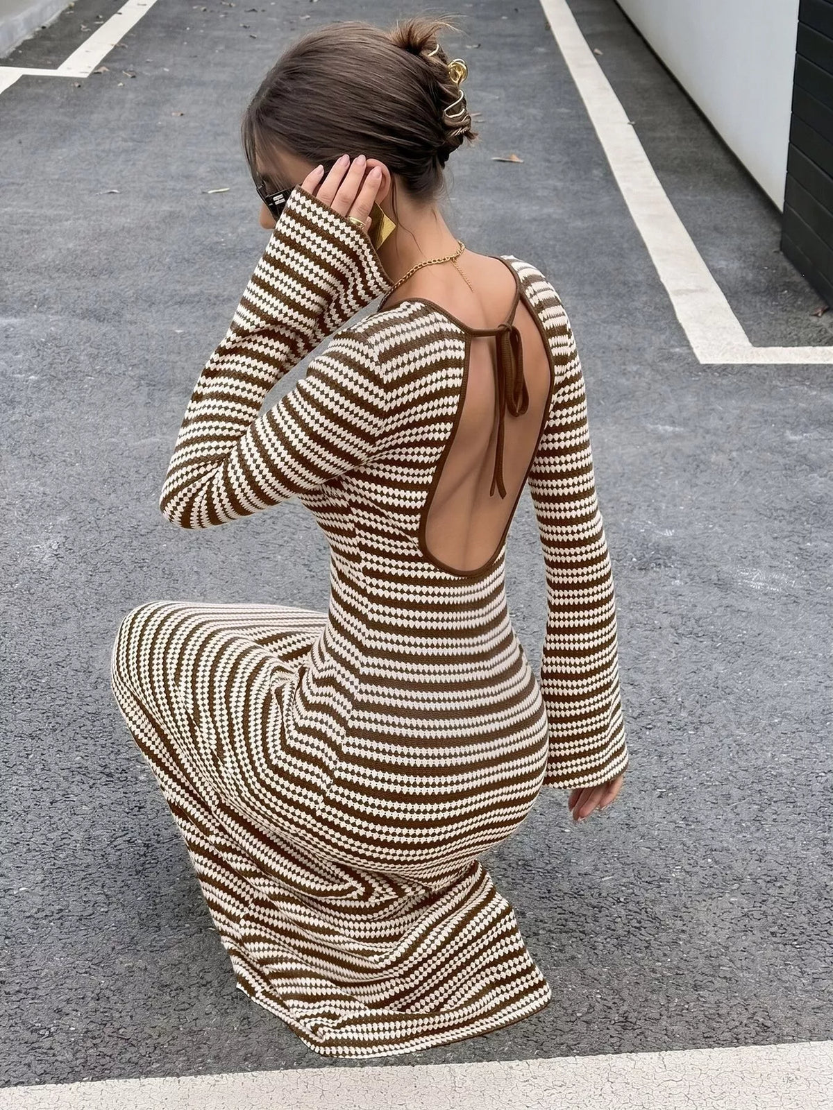 Brown striped ribbed knit dress with open back and long flared sleeves