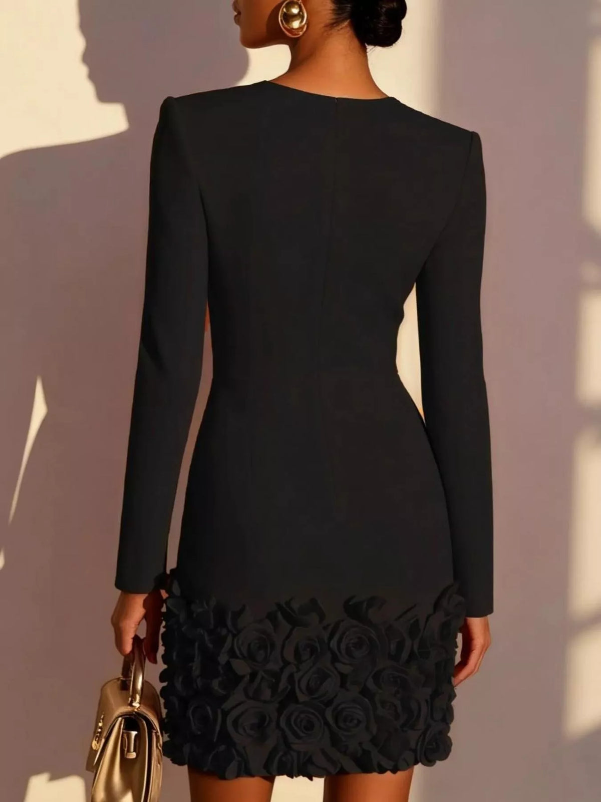 Back view black V-neck long sleeve mini dress with 3D rose floral hem.