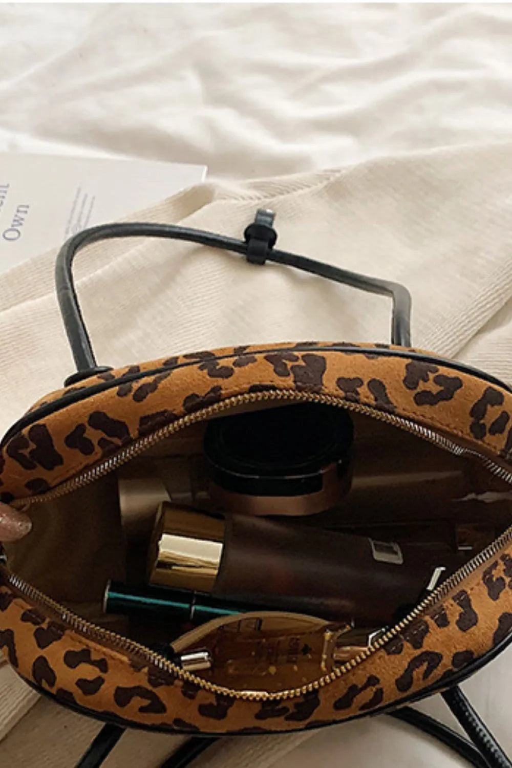 Caramel leopard suede medium shoulder bag open with zippered interior pockets