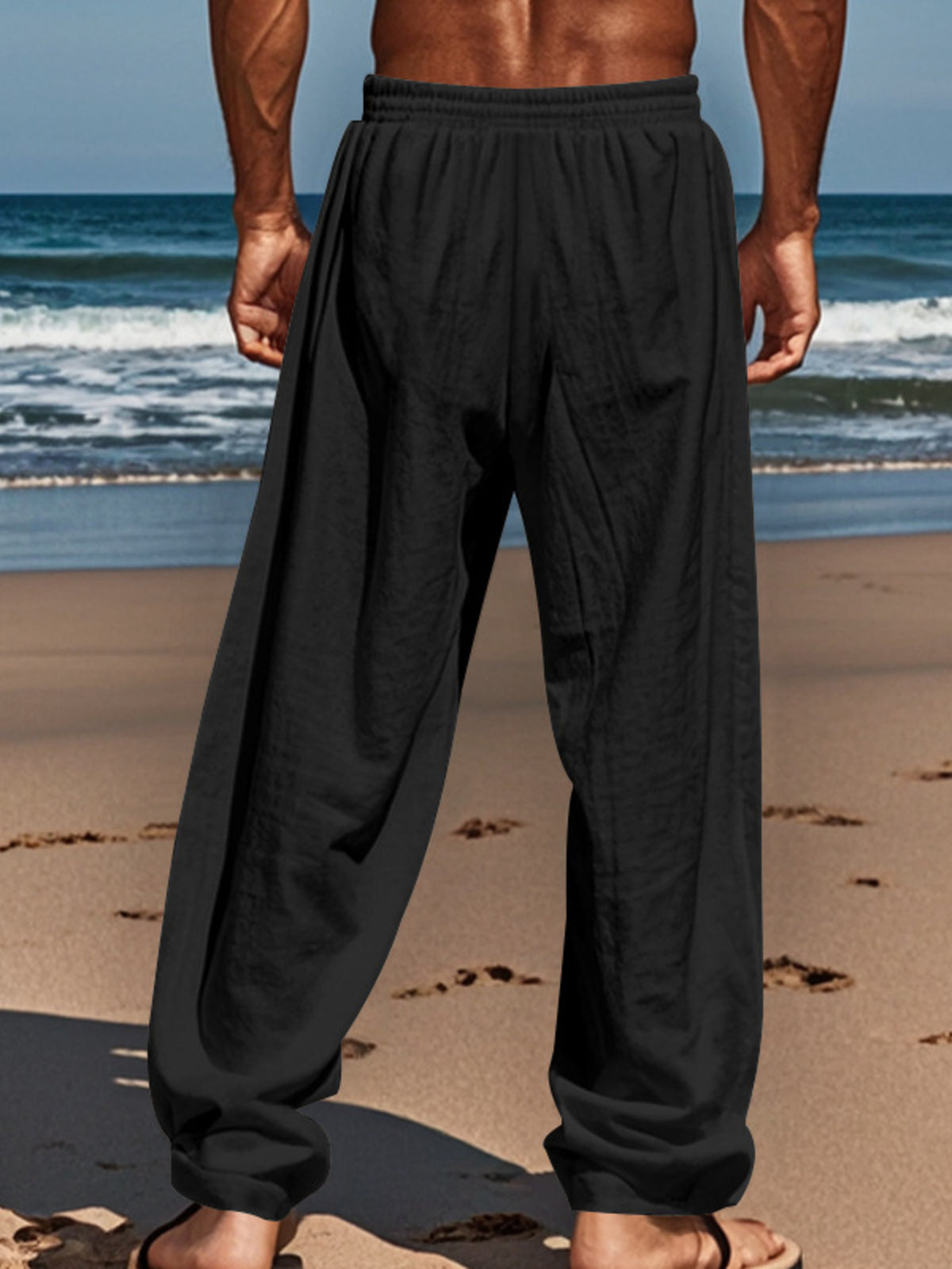 Black drawstring pants with elastic waistband and roomy straight-leg silhouette