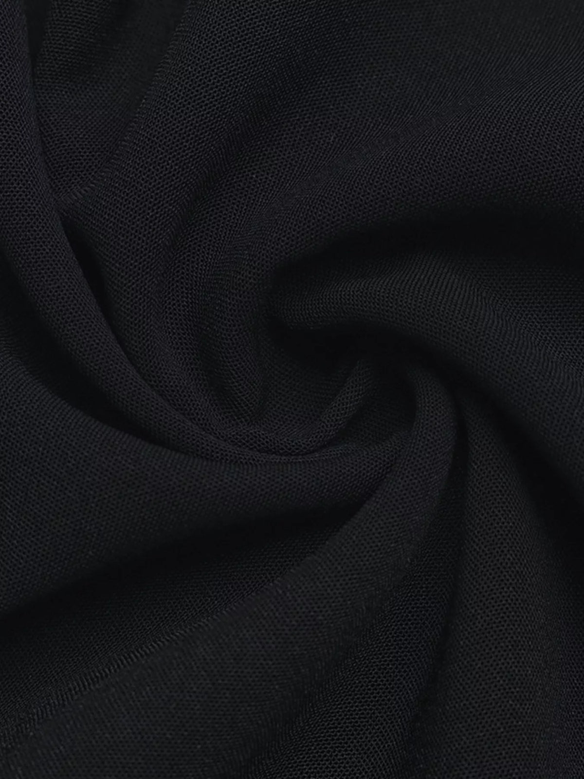Black textured fabric close-up with soft drape