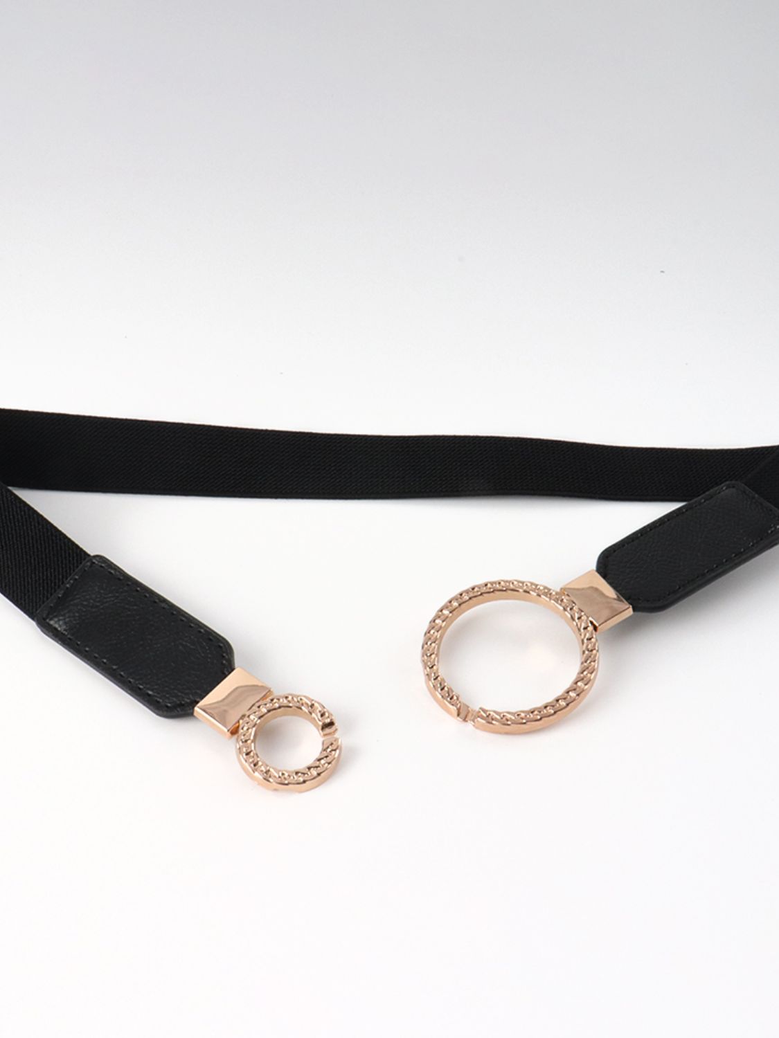 Black elastic vegan leather belt with double-ring buckle hardware and loop ends