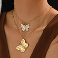 Gold-tone rhinestone butterfly and flower charm necklace set, two-layer chain