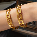 Gold hollow square link chain bracelet on wrist with visible clasp