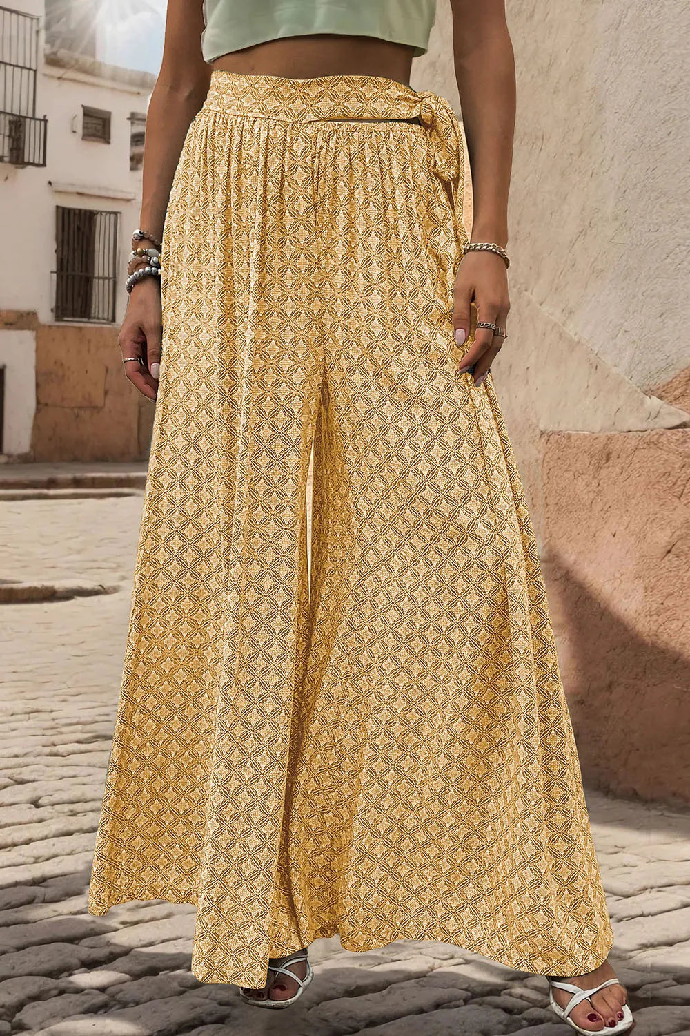 Yellow printed wide-leg pants with gathered elastic waistband and loose drape
