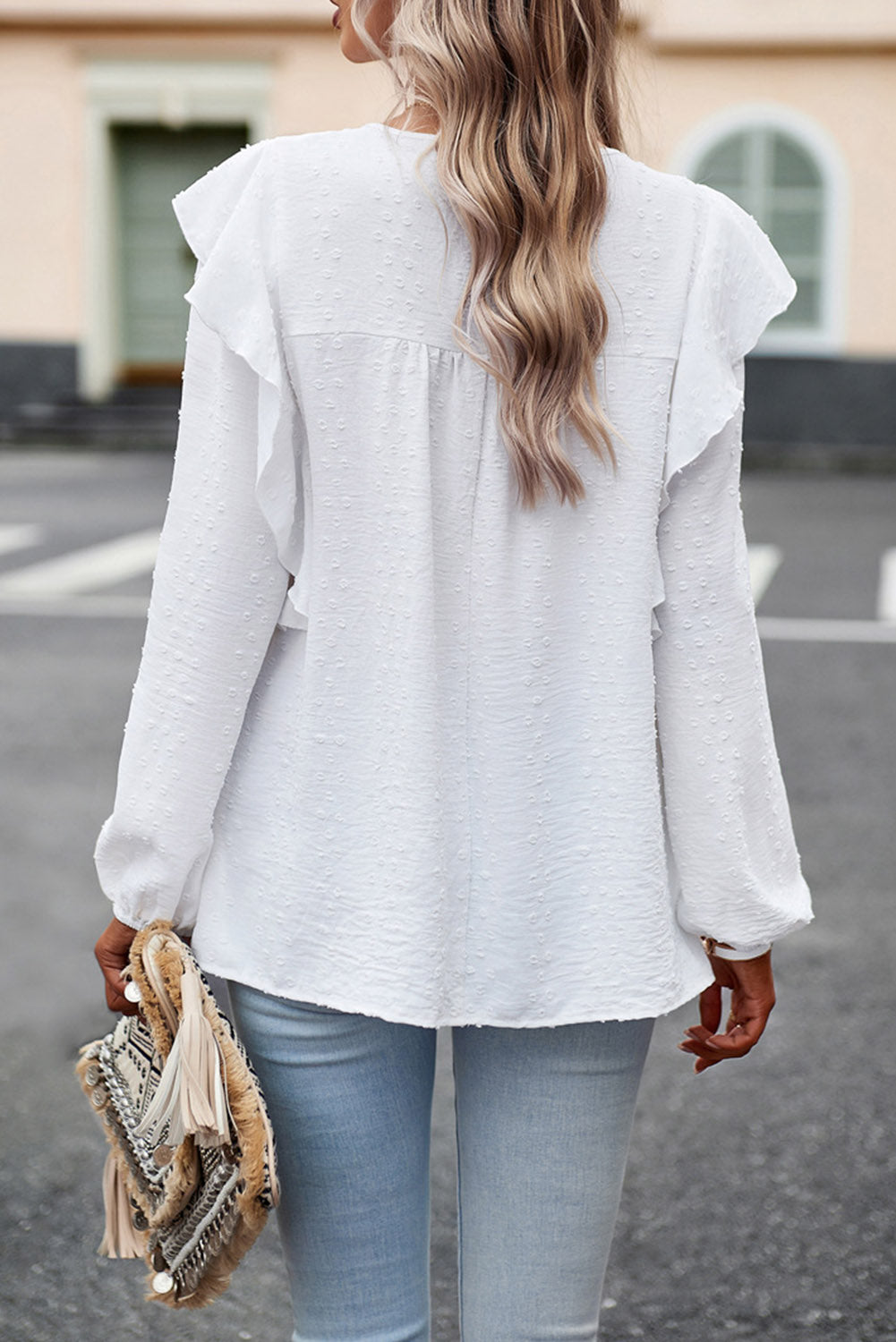 Ruffled round-neck blouse in white with long sleeves and draped back ruffles