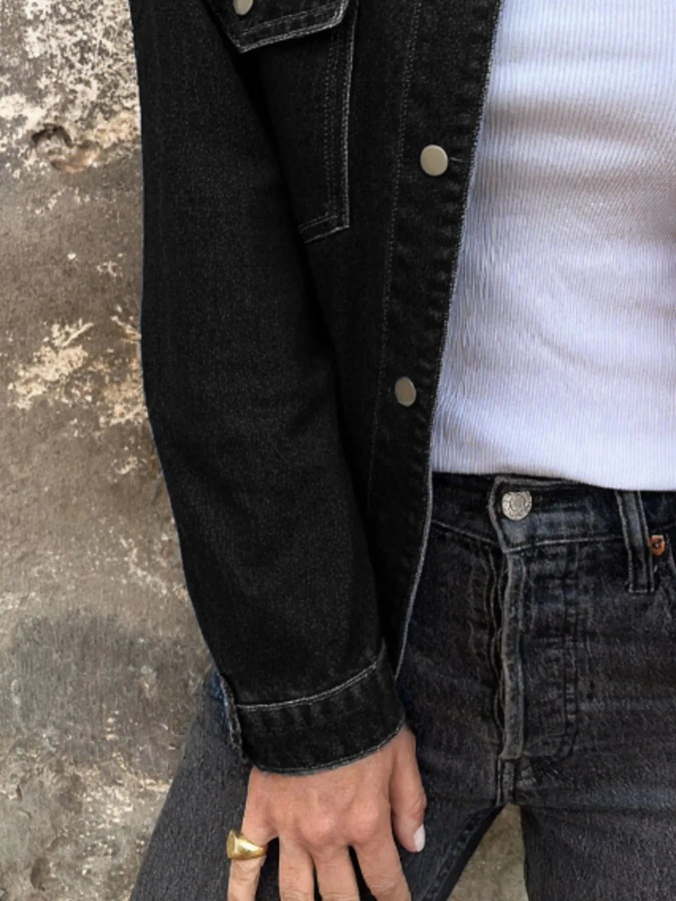 Black denim jacket sleeve with button placket and cuff detail