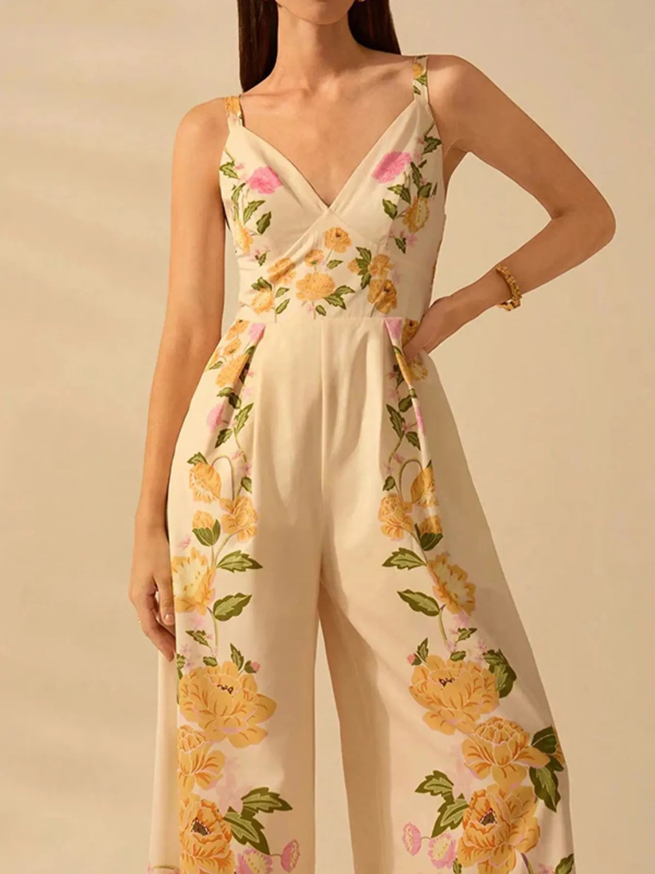 Cream floral wide-leg v-neck cami jumpsuit with spaghetti straps and matching hem trim