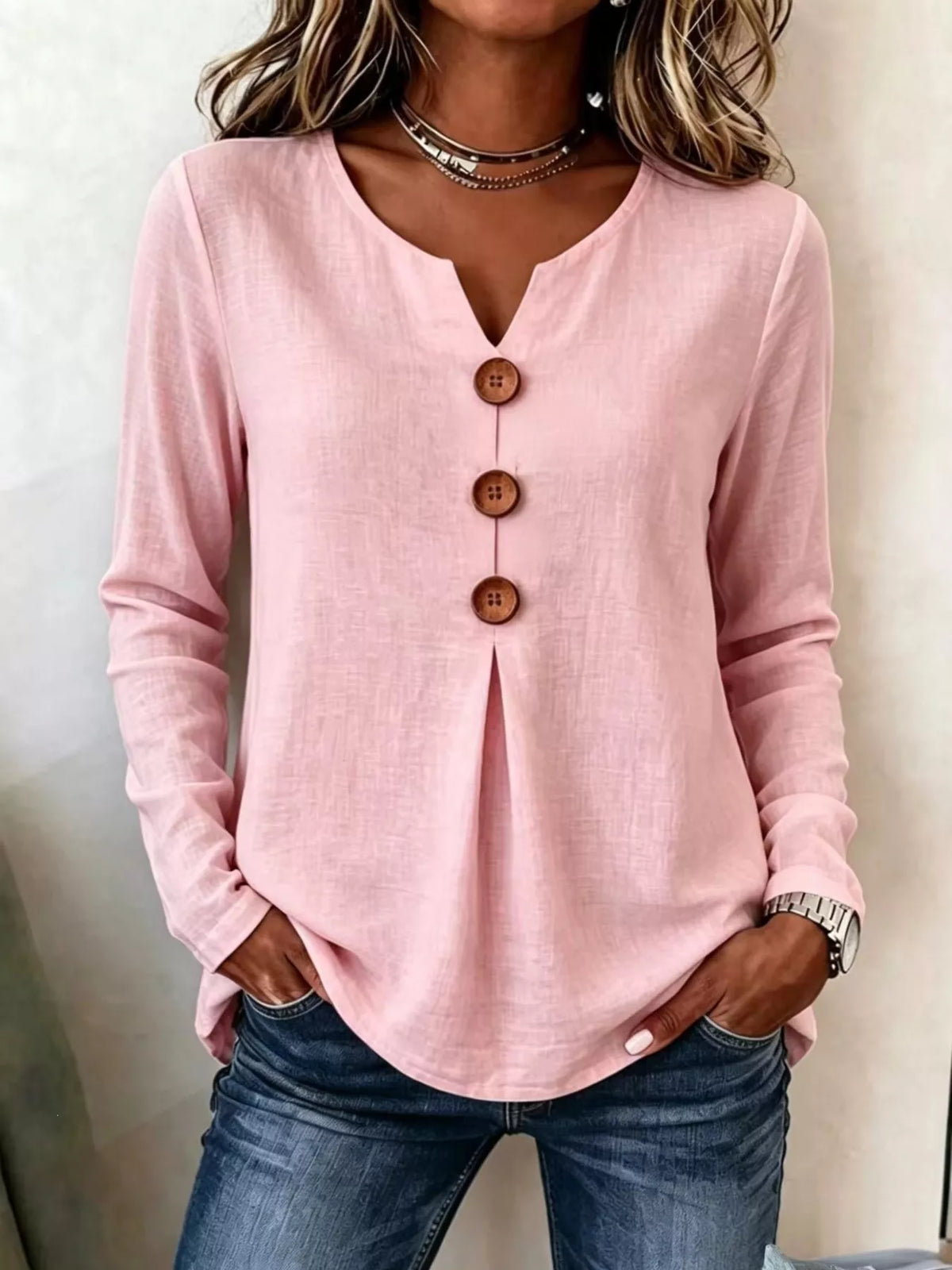 Pink long sleeve blouse with V-neck and decorative button placket