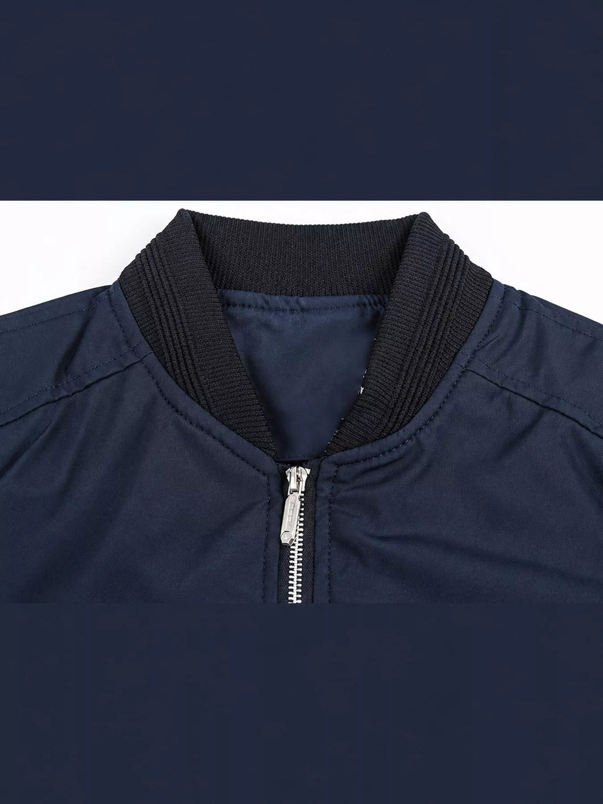 Men's navy bomber jacket close-up, stand collar with metal zipper and ribbed trim