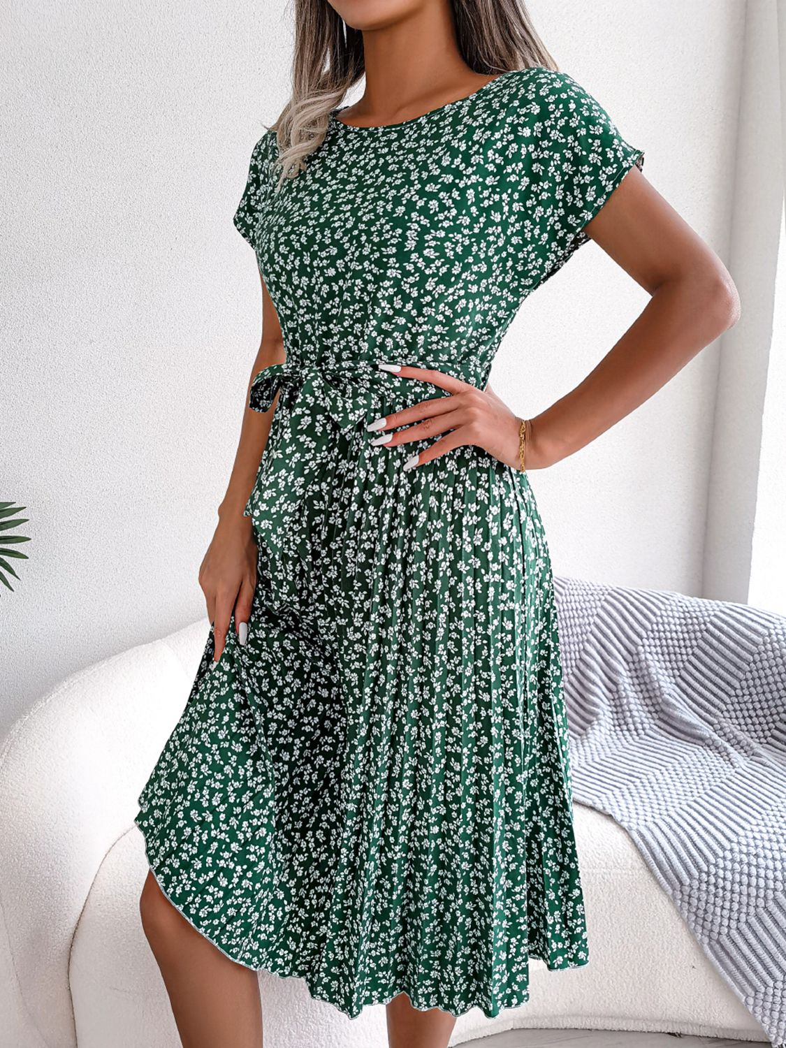 Green ditsy floral pleated belted dress with short sleeves and tie waist