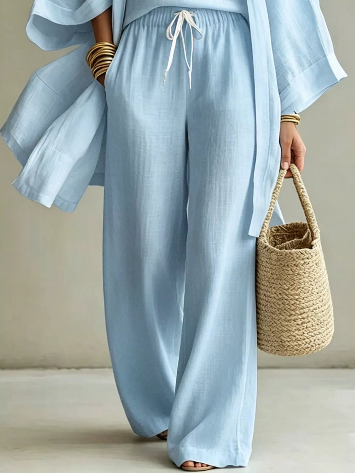 Sky blue drawstring waist wide-leg pants with open cardigan, side view