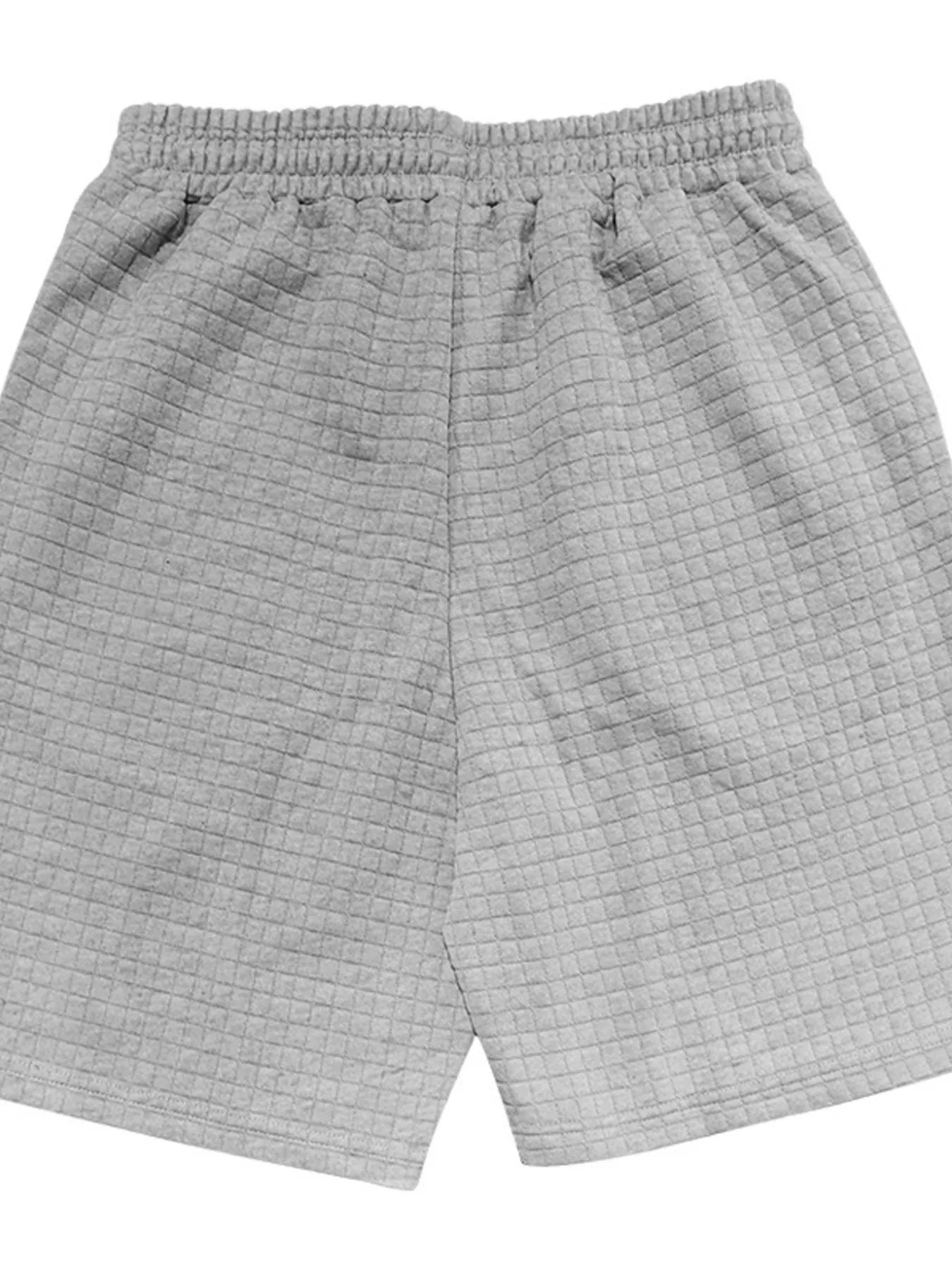 Light gray drawstring shorts with elastic waist and textured woven look