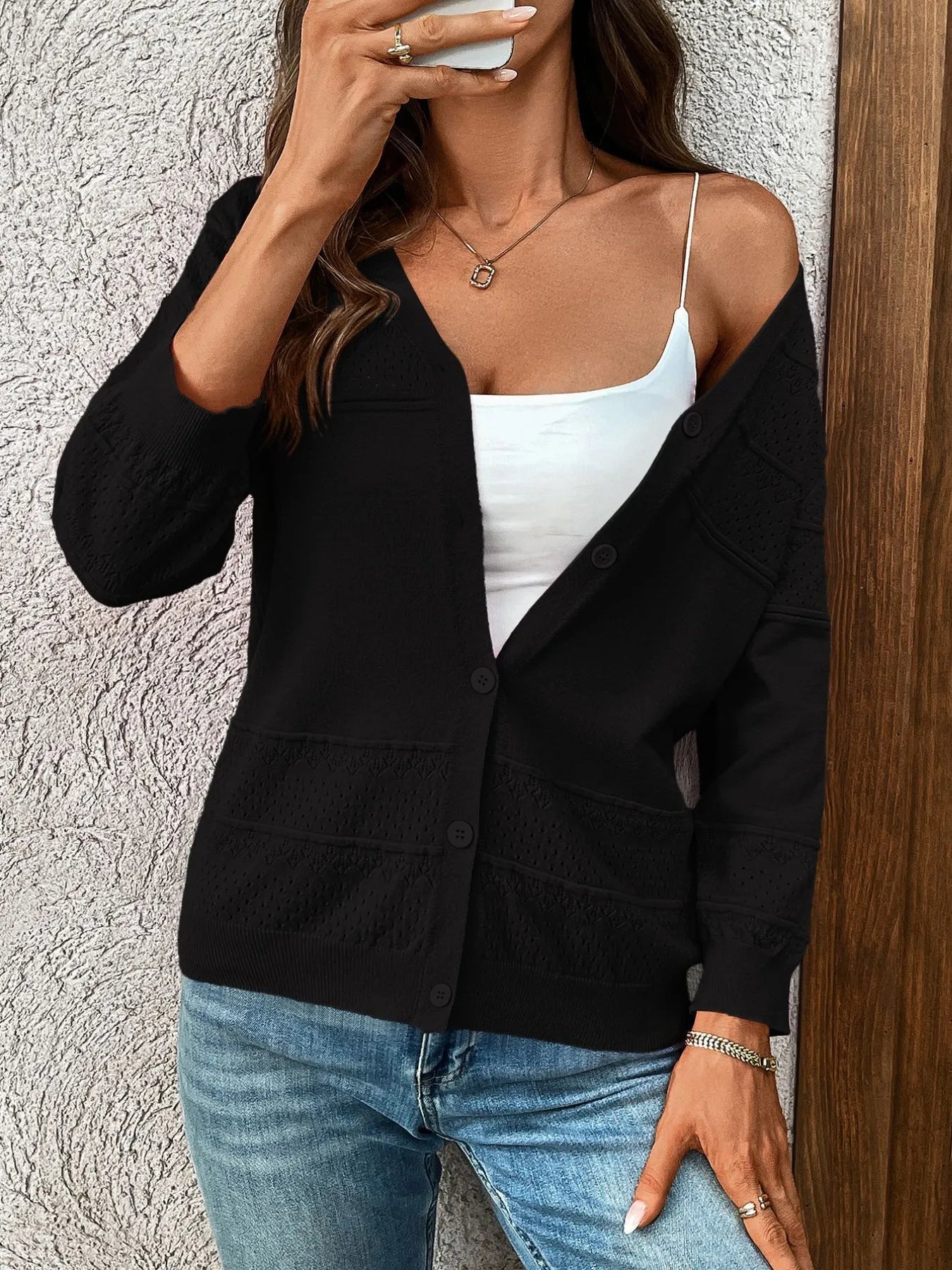 Textured black button-front cardigan with 3/4 sleeves and patch pockets