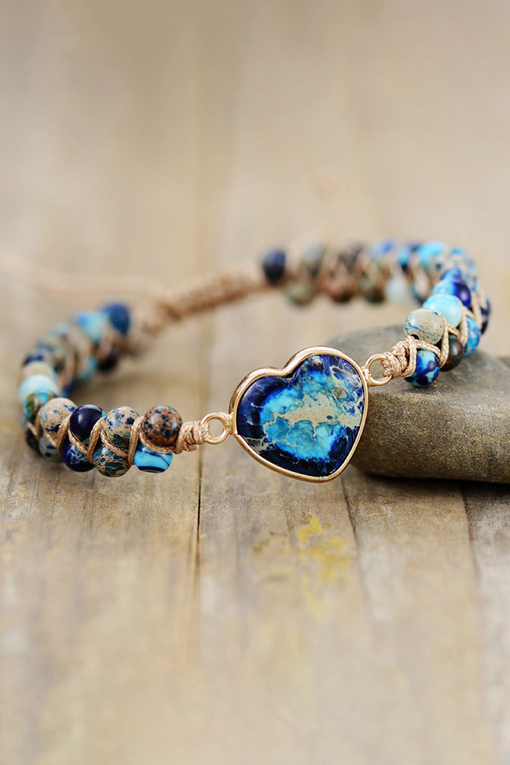 Blue beaded heart bracelet with gold-tone heart pendant and adjustable cord ties
