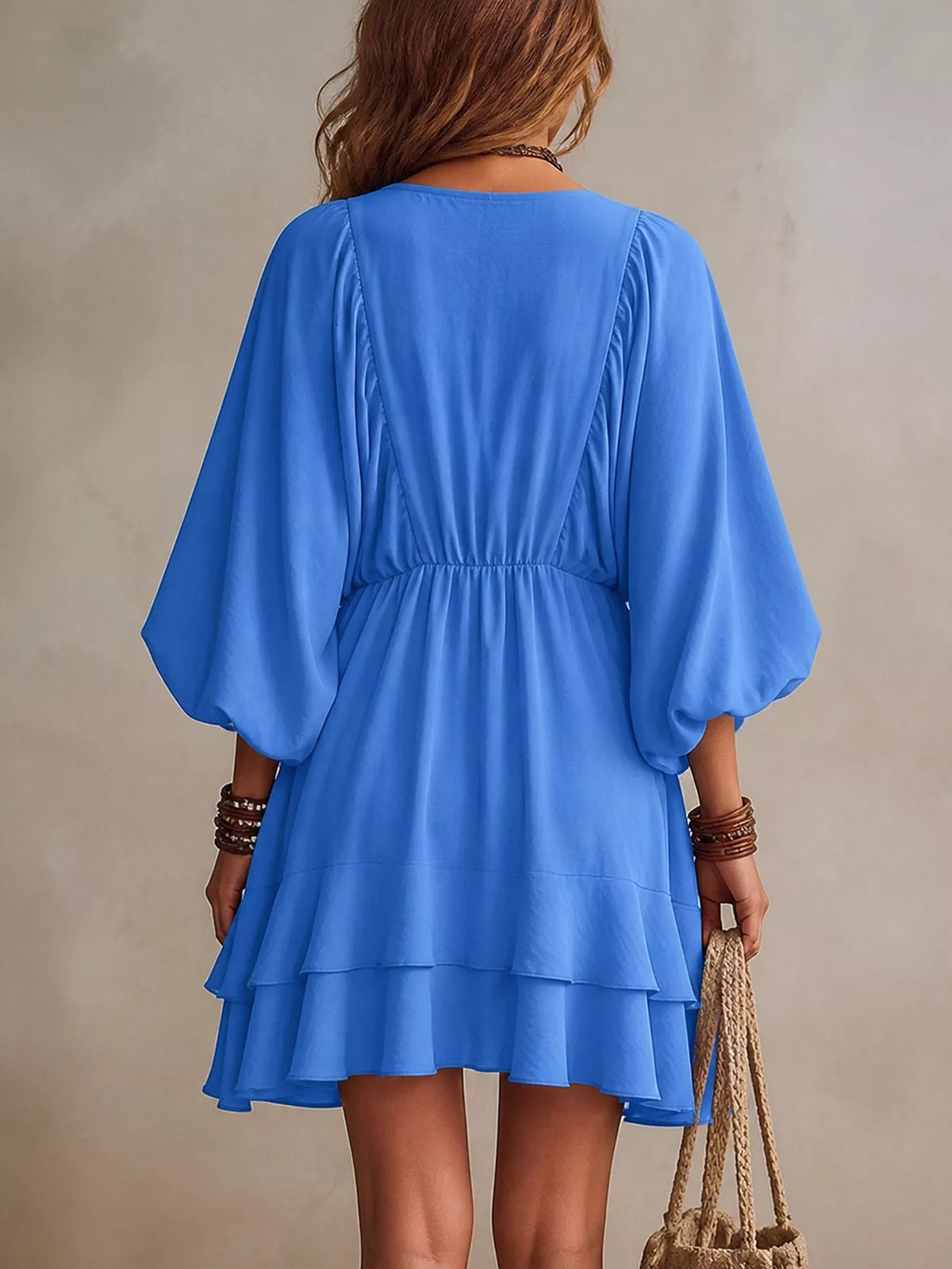 Blue tiered mini dress back view with balloon sleeves and gathered waist