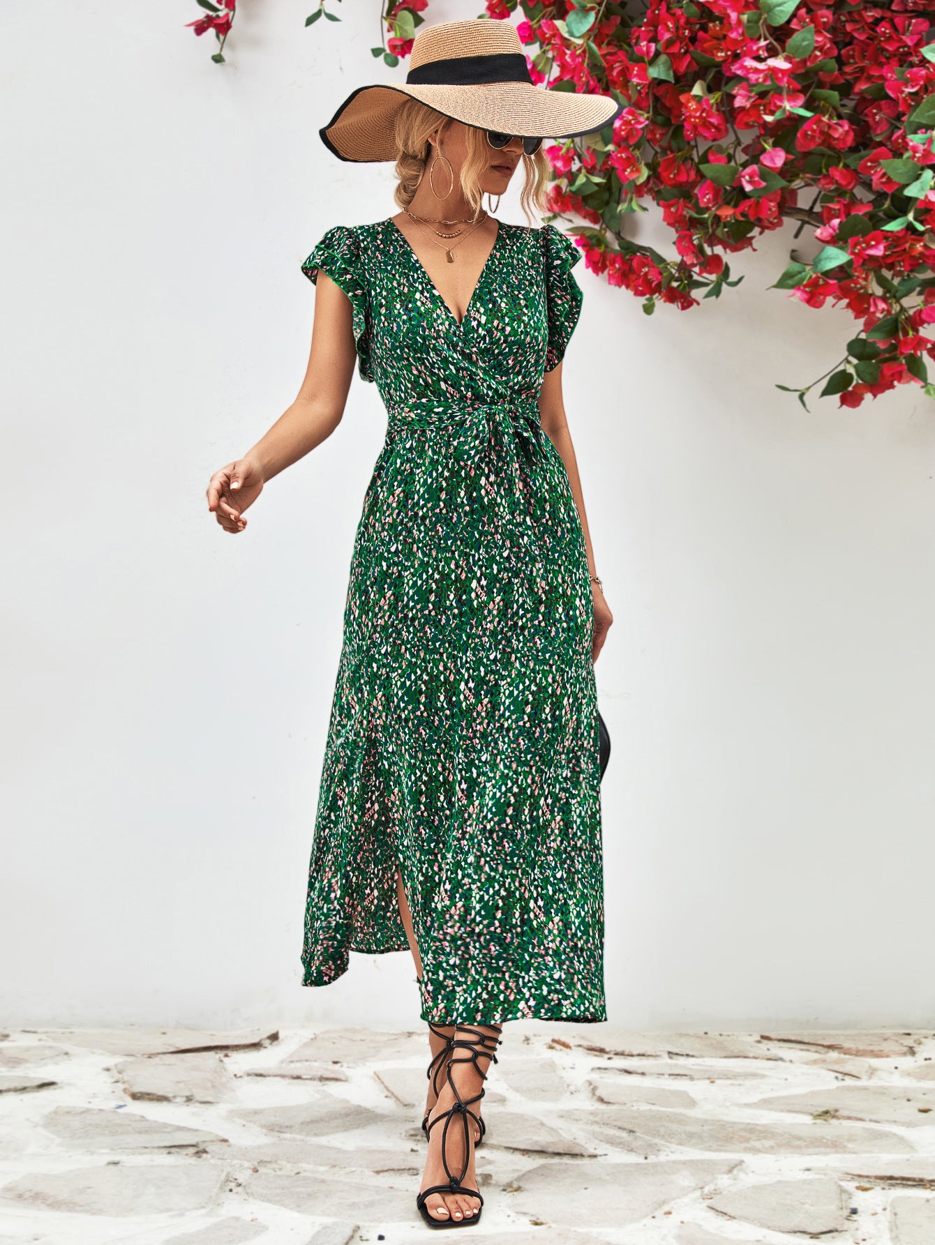 Green printed surplice neck flutter sleeve slit dress, midi length with fitted waist and V neckline.