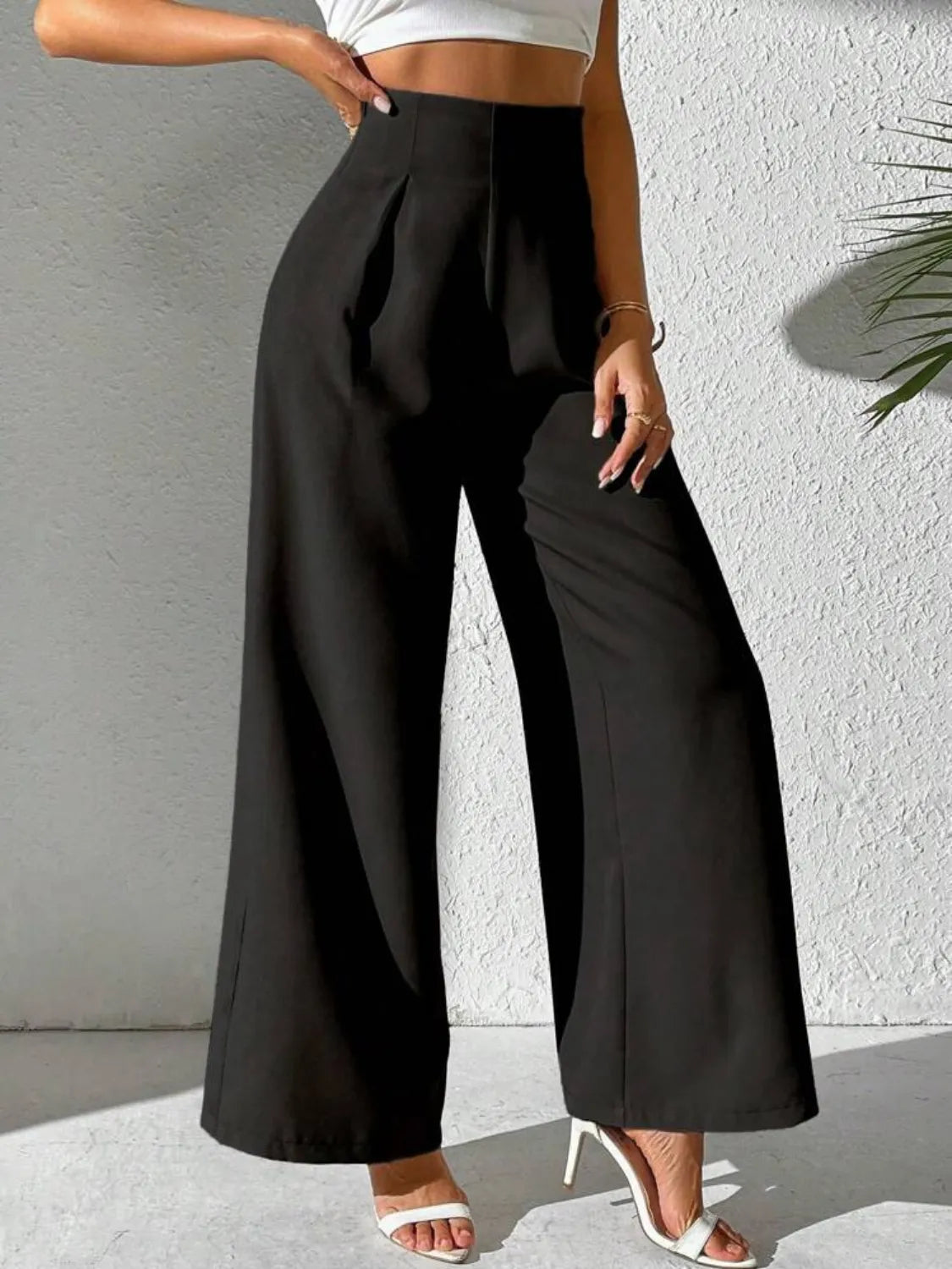 Black wide-leg high-waist pants with pleated front and full-length flared legs