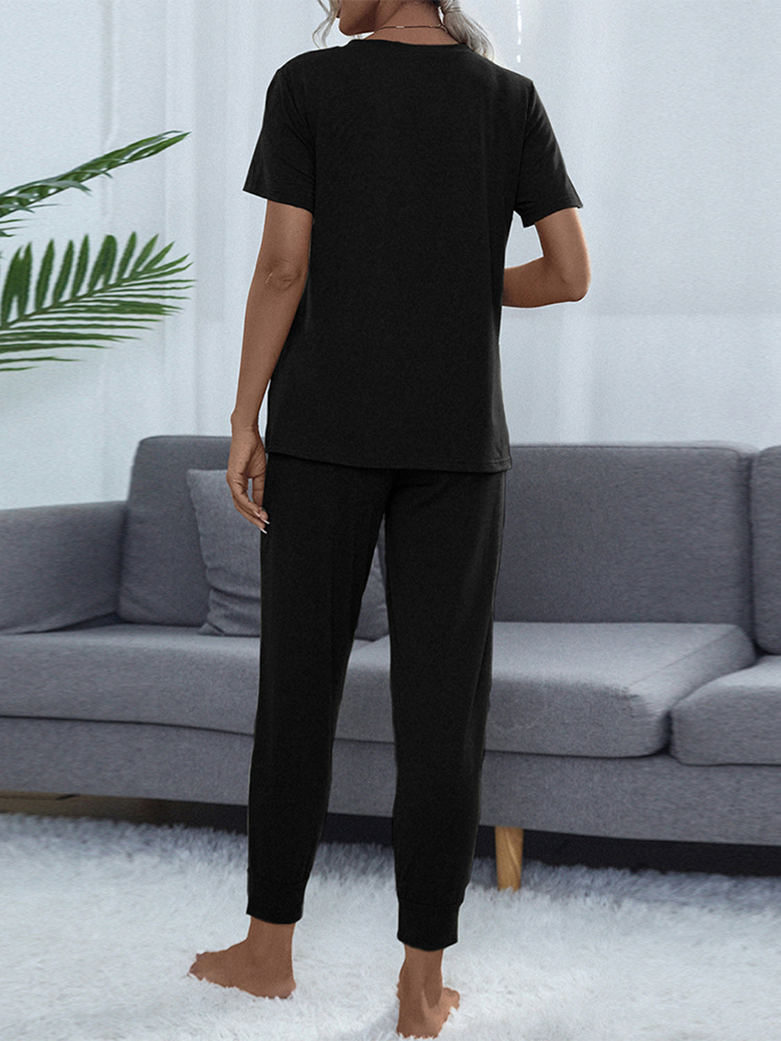 Shiny round-neck short-sleeve top and jogger pants set, black, back view